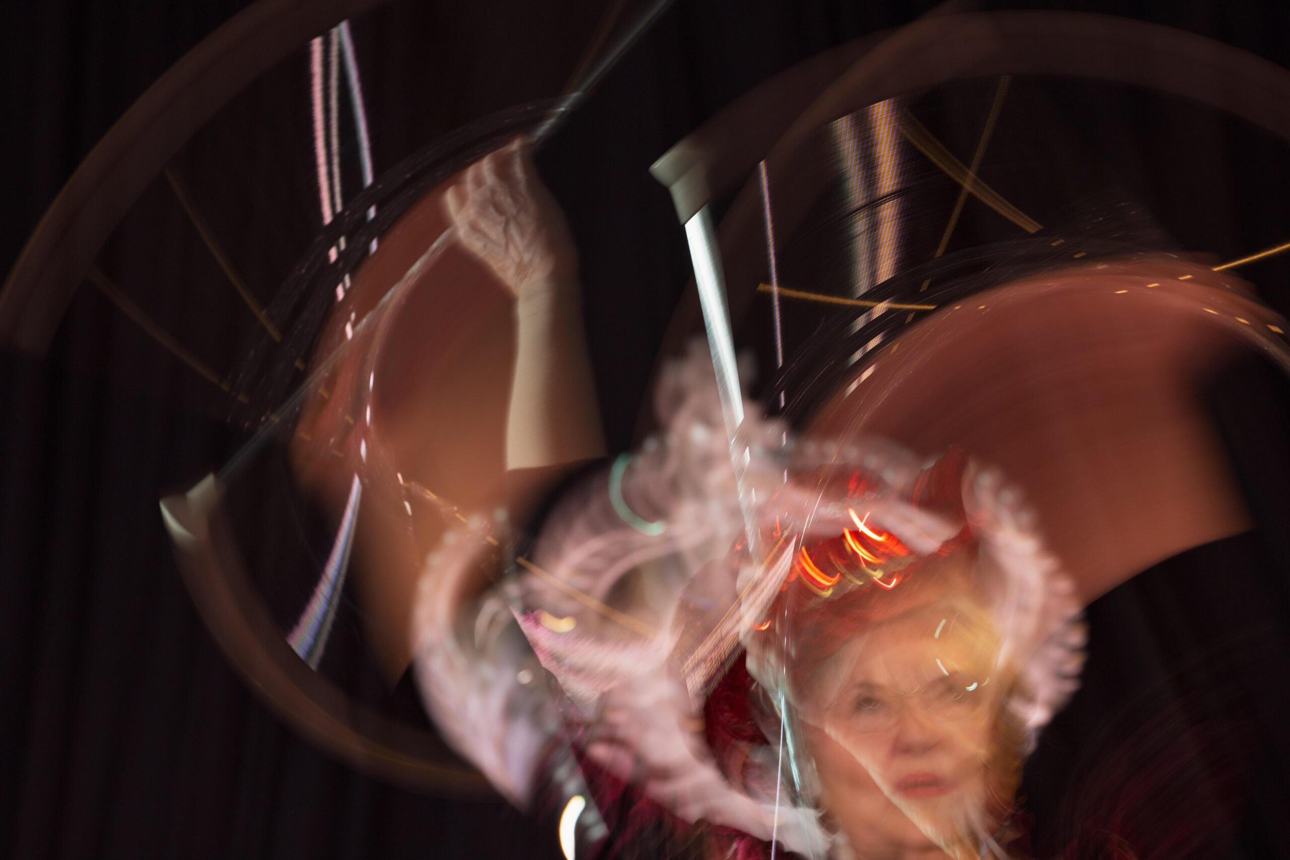 A multiple exposure photo showing an older white woman twirling a baton.
