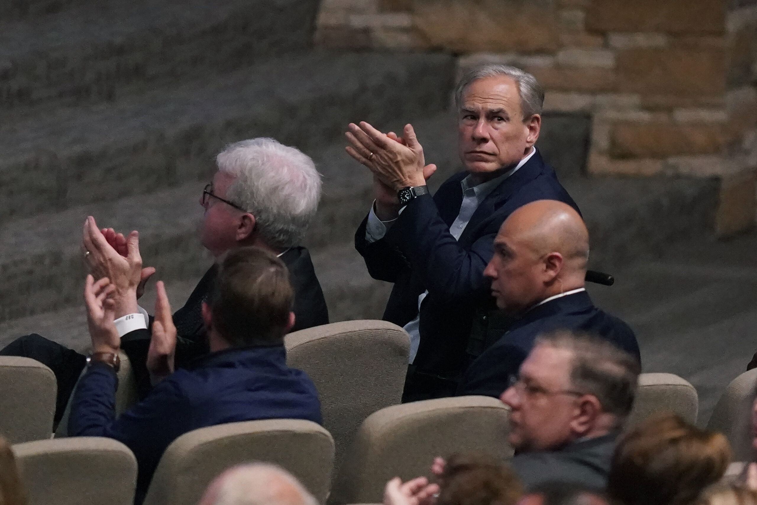 Texas Governor Greg Abbott, right, and others applaud during a prayer vigil after a mass shooting the day before Sunday, May 7, 2023, in Allen, Texas.