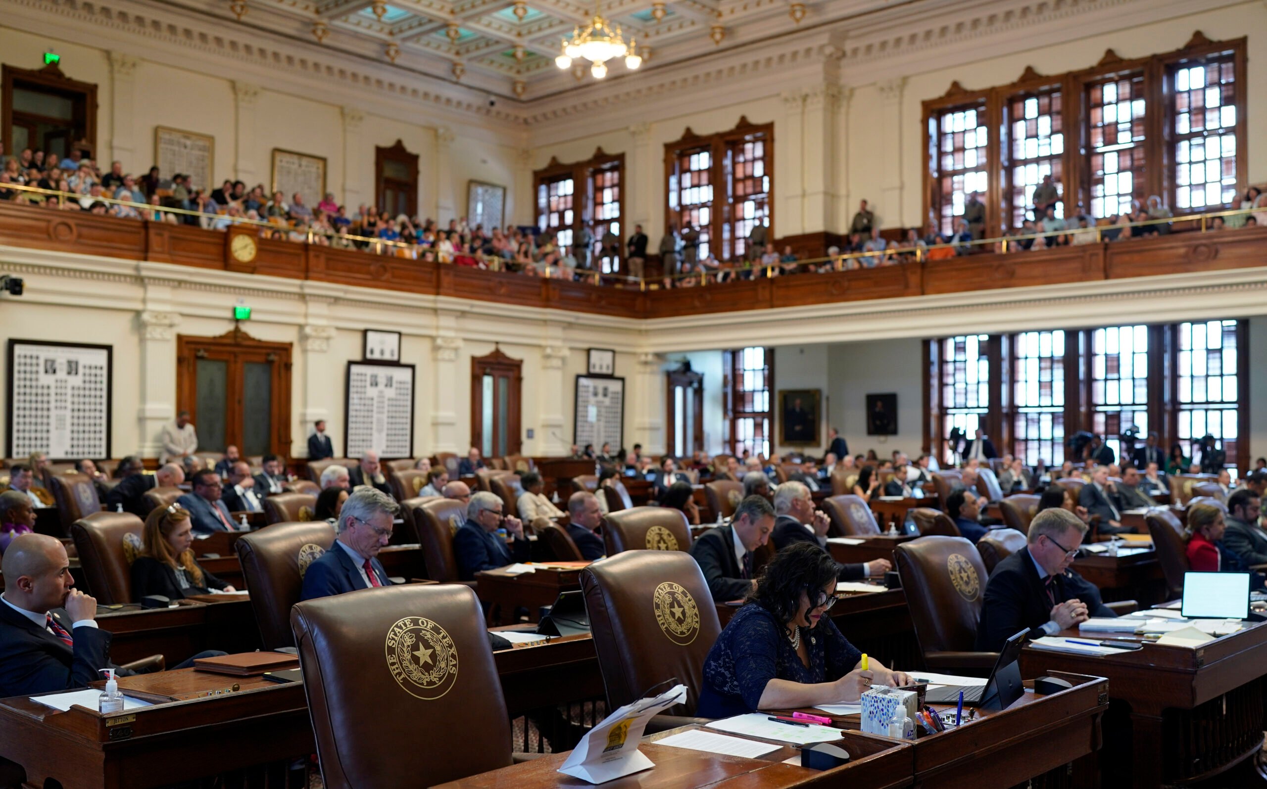 House members and visitors listen to the impeachment proceedings against state Attorney General Ken Paxton in the House Chamber at the Texas Capitol in Austin, Texas, Saturday, May 27, 2023. Texas lawmakers have issued 20 articles of impeachment against Paxton, ranging from bribery to abuse of public trust as state Republicans surged toward a swift and sudden vote that could remove him from office. (AP Photo/Eric Gay)