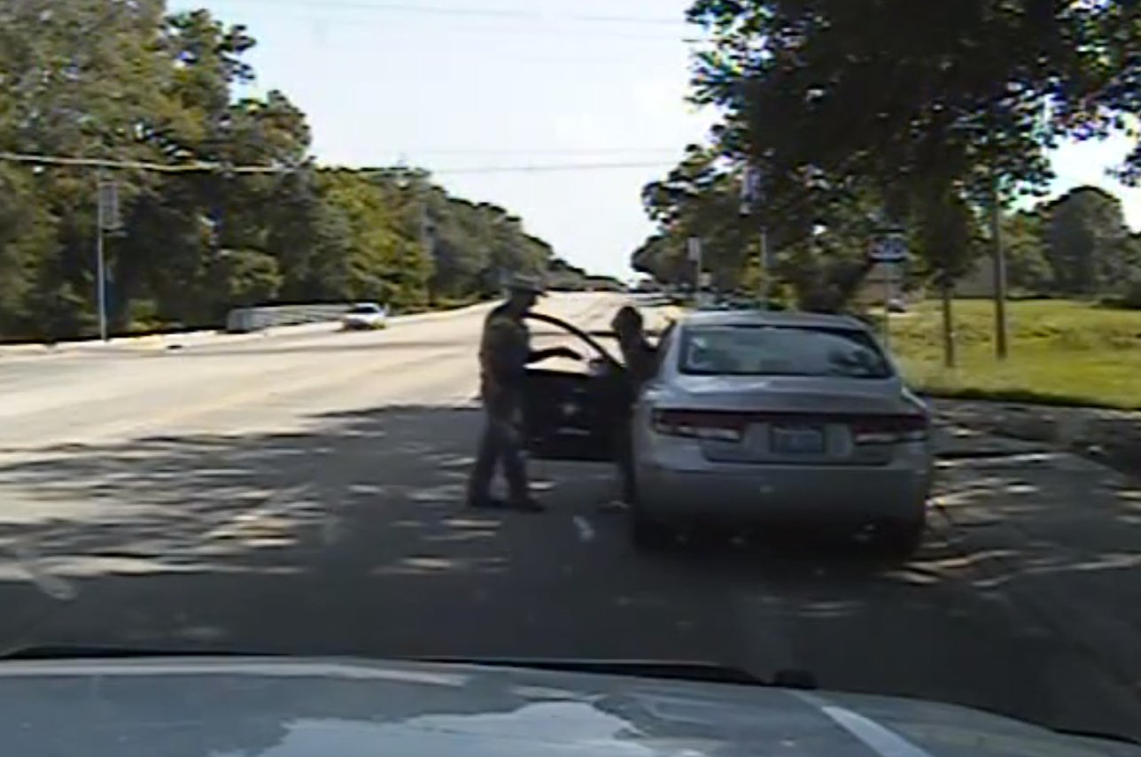 In this July 10, 2015, frame from dashcam video provided by the Texas Department of Public Safety, a heated confrontation between trooper Brian Encinia leads to the arrest of Sandra Bland after a minor traffic infraction in which the state trooper tried to drag Bland from her car, drew his stun gun and threatened that he would "light you up" in Waller County, Texas. Bland was taken to the Waller County Jail that day and was found dead in her cell on July 13.