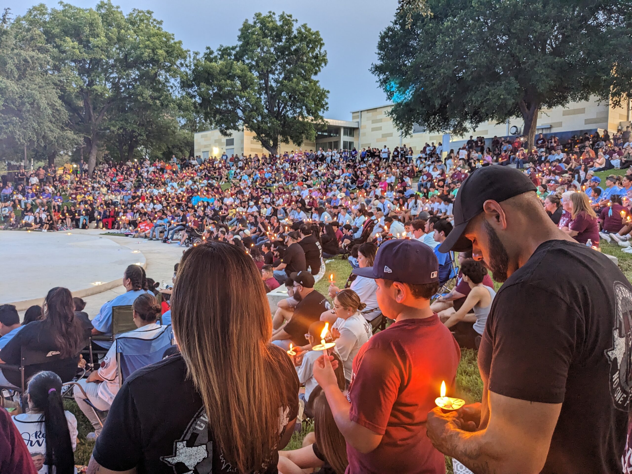 hundreds gathered for a vigil at an outdoor amphitheater sandwiched between the city’s civic center and the Leona River.