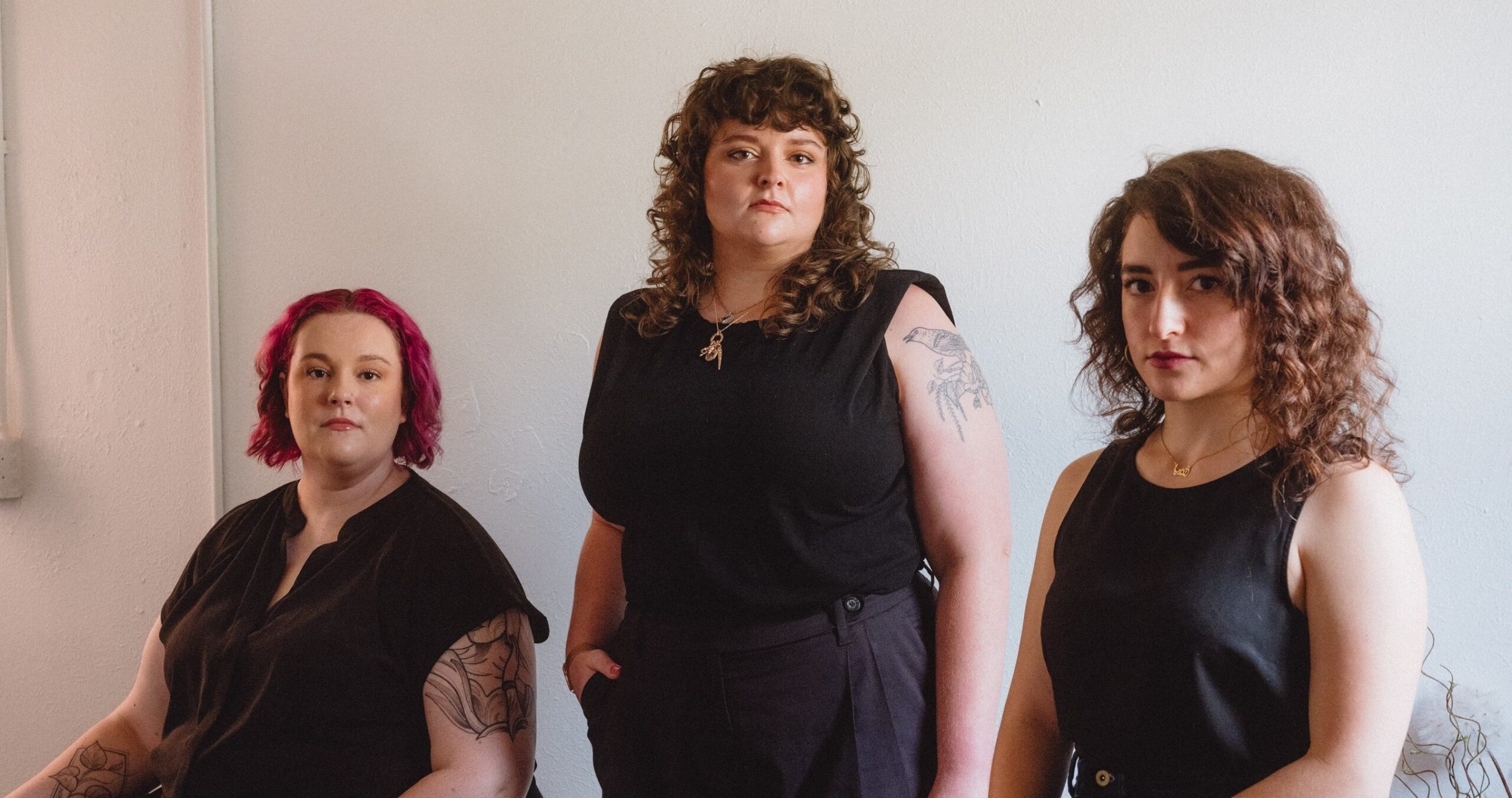 Andie Haddad, class of 2013, Walden Hagelman, class of 2014, and Dana Havlin, class of 2015, all alumni of James Bowie High School in Austin, Texas, pose for a portrait on June 24, 2023.