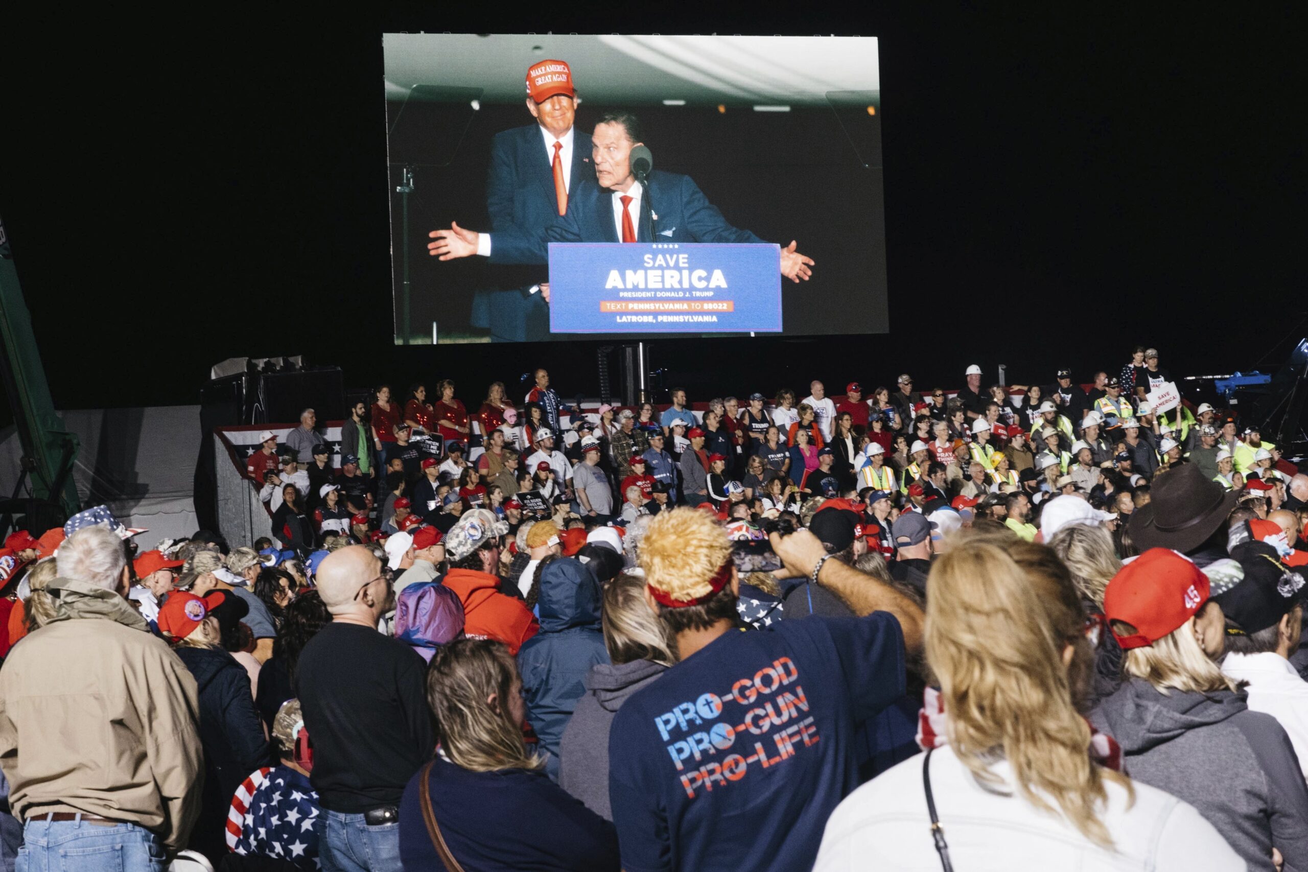 Visitors watch Kenneth Copeland, who was invited by former President Donald Trump at a rally in Latrobe, Pennsylvania.