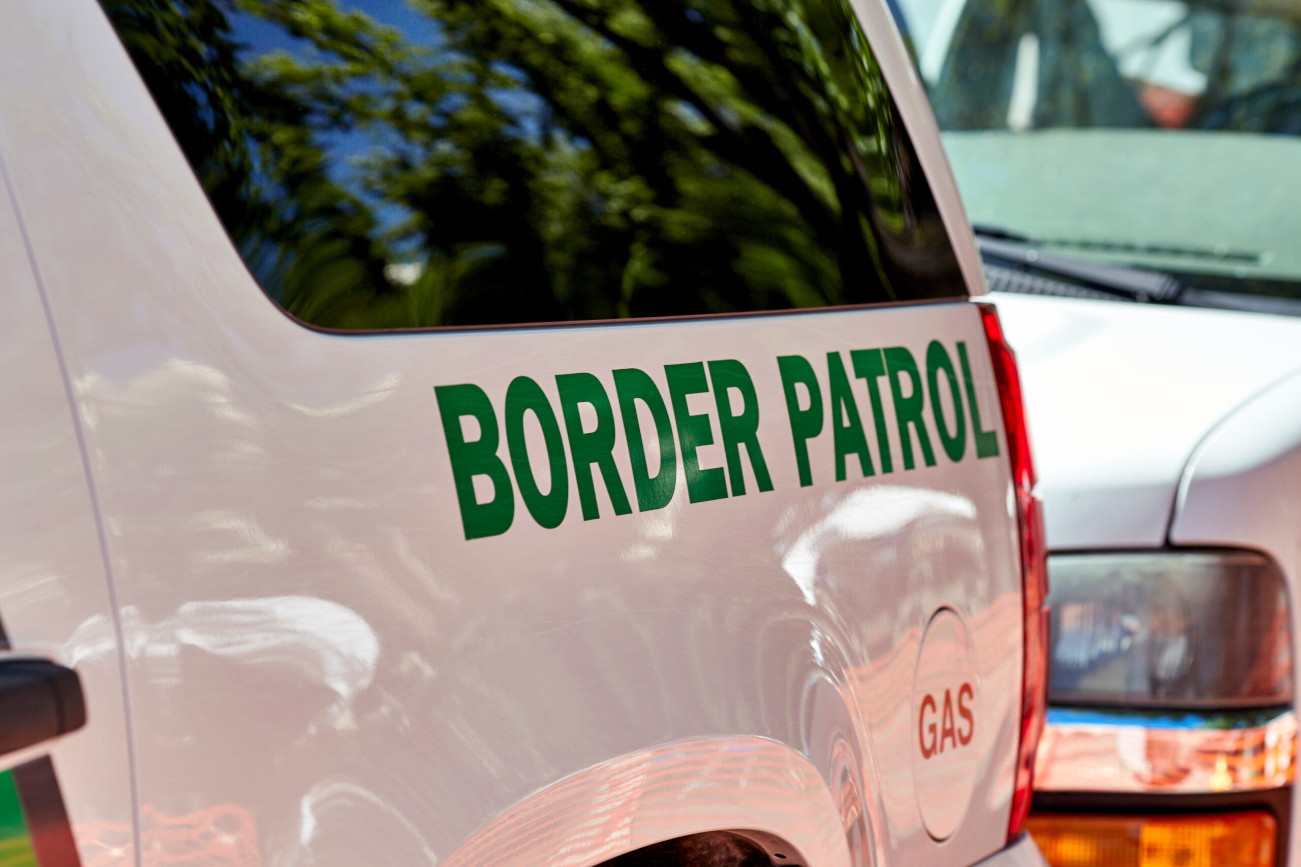 A U.S. Customs and Border Patrol police cruiser, in the SUV style, in white with green text on the side.