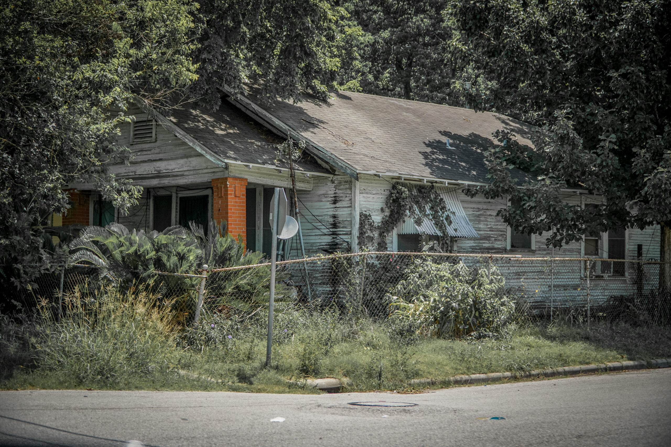 A run-down house, partly covered in kudzu, in Houston's third ward.