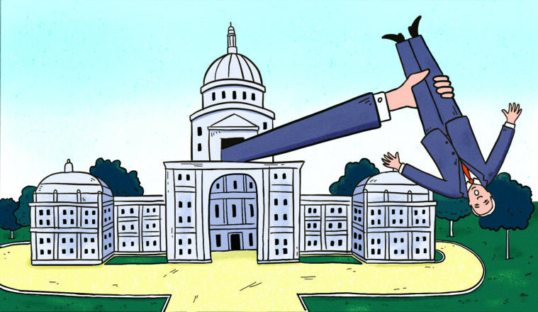 A cartoon showing a hand emerging from the dome of the Texas Capitol, grabbing Ken Paxton upside down by one leg.