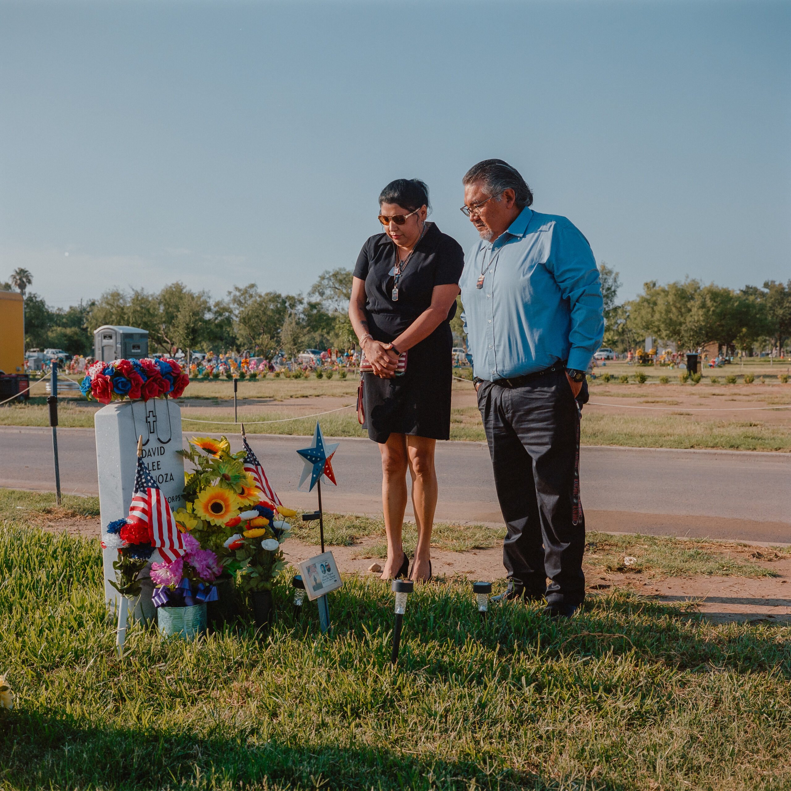 Holguin and Dominguez pause at their son's gravesite on Memorial Day.