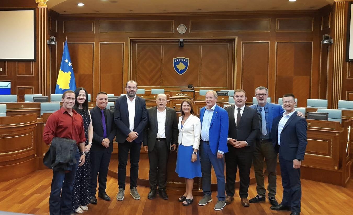 Ken and Angela Paxton (center) surrounded by members of the Kosovo Parliament 