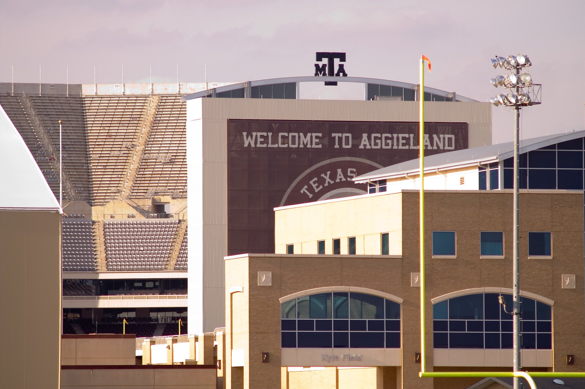 An image of Texas A&M University with a building emblazoned with the phrase "Welcome to Aggieland"
