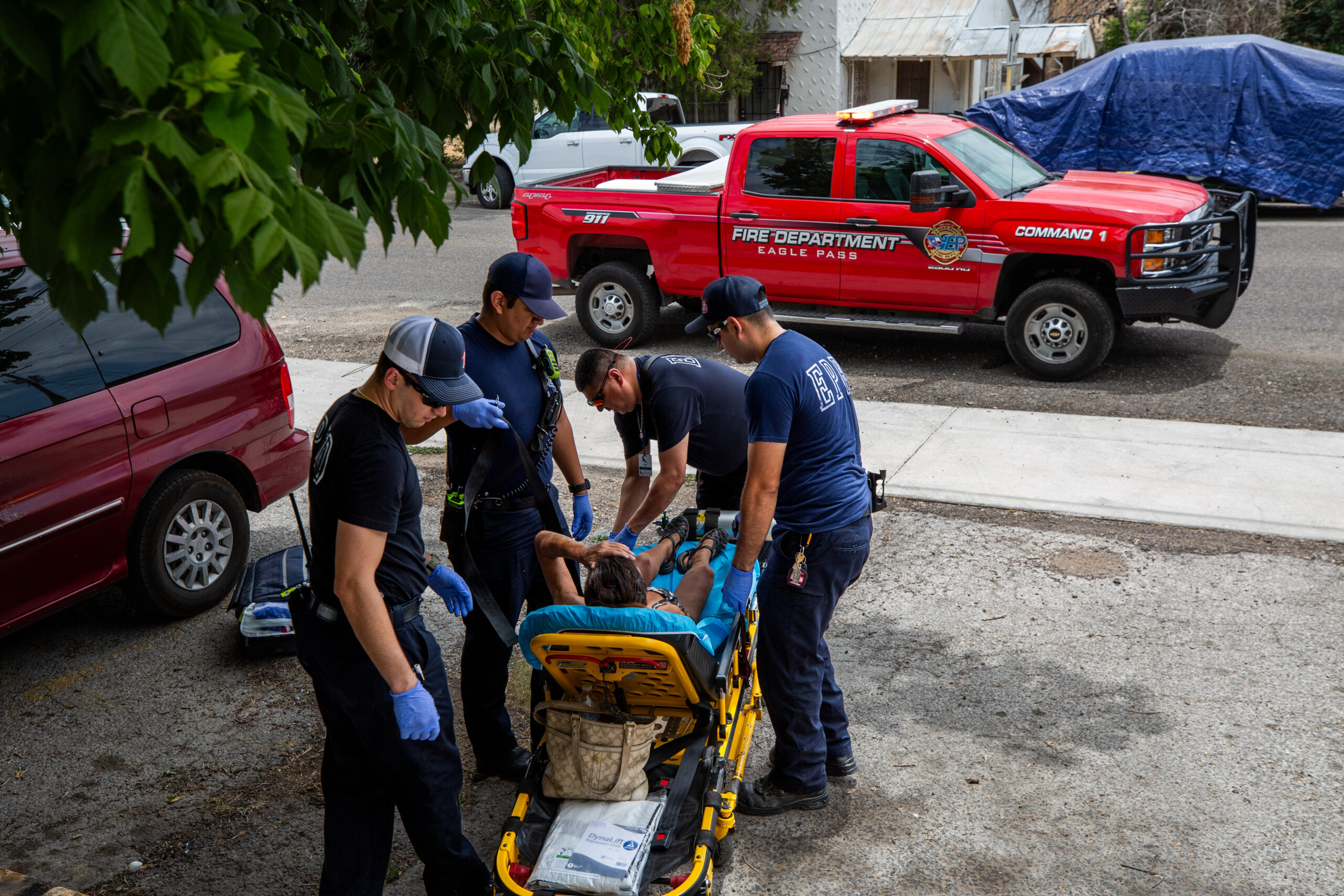 From left to right, firefighter EMTs Harish Garcia, Jose Garza, Luis Huerta, and Pedro Olivares transport a disoriented woman to the hospital.