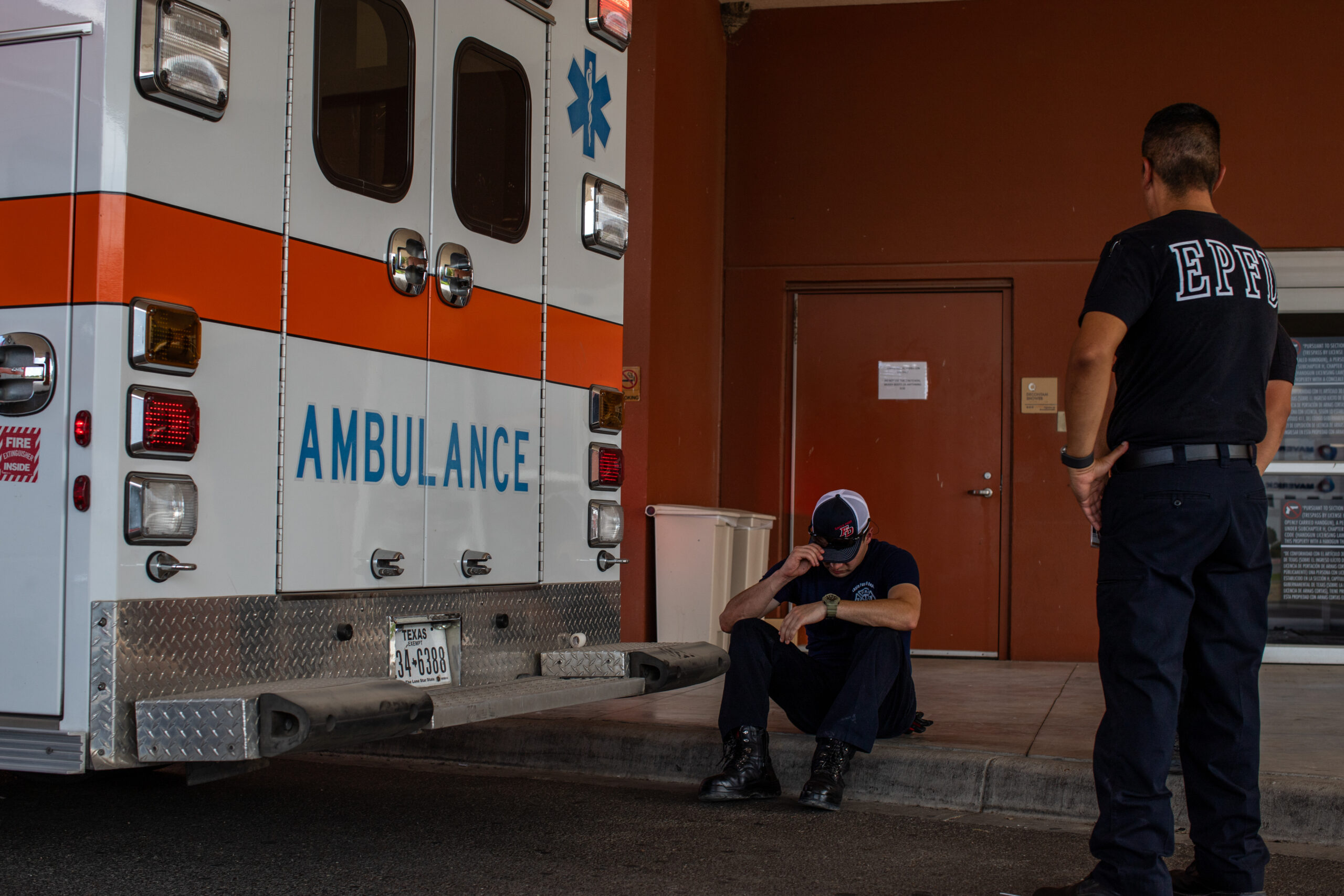 Garcia, left, and trainee Marco Lopez wait for team members to return to the ambulance bay.