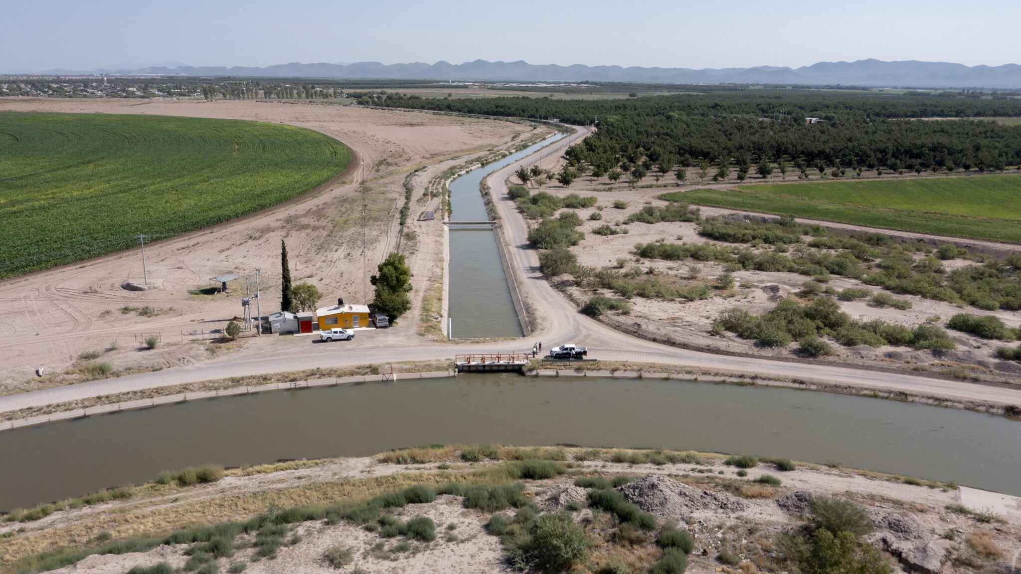 An irrigation canal winds its way through a desert landscape.
