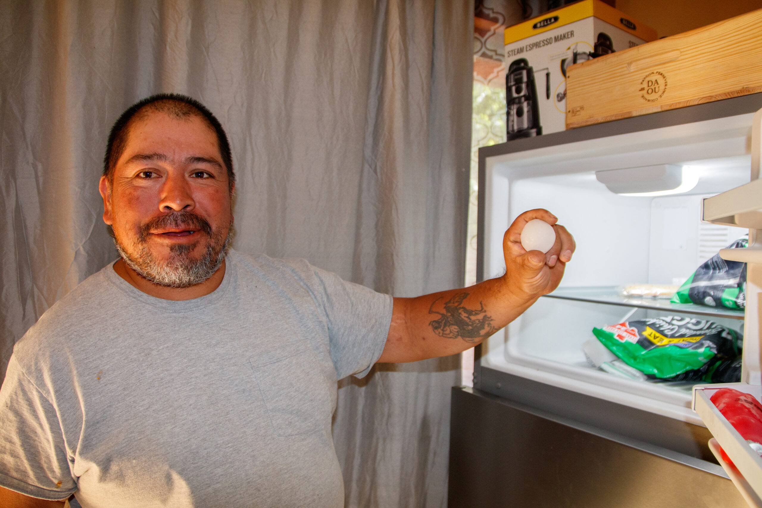 Gregorio Marcias, who builds fences for a living, holds up a hailstone that he collected when a violent hailstorm hit his Round Rock neighborhood September 24.