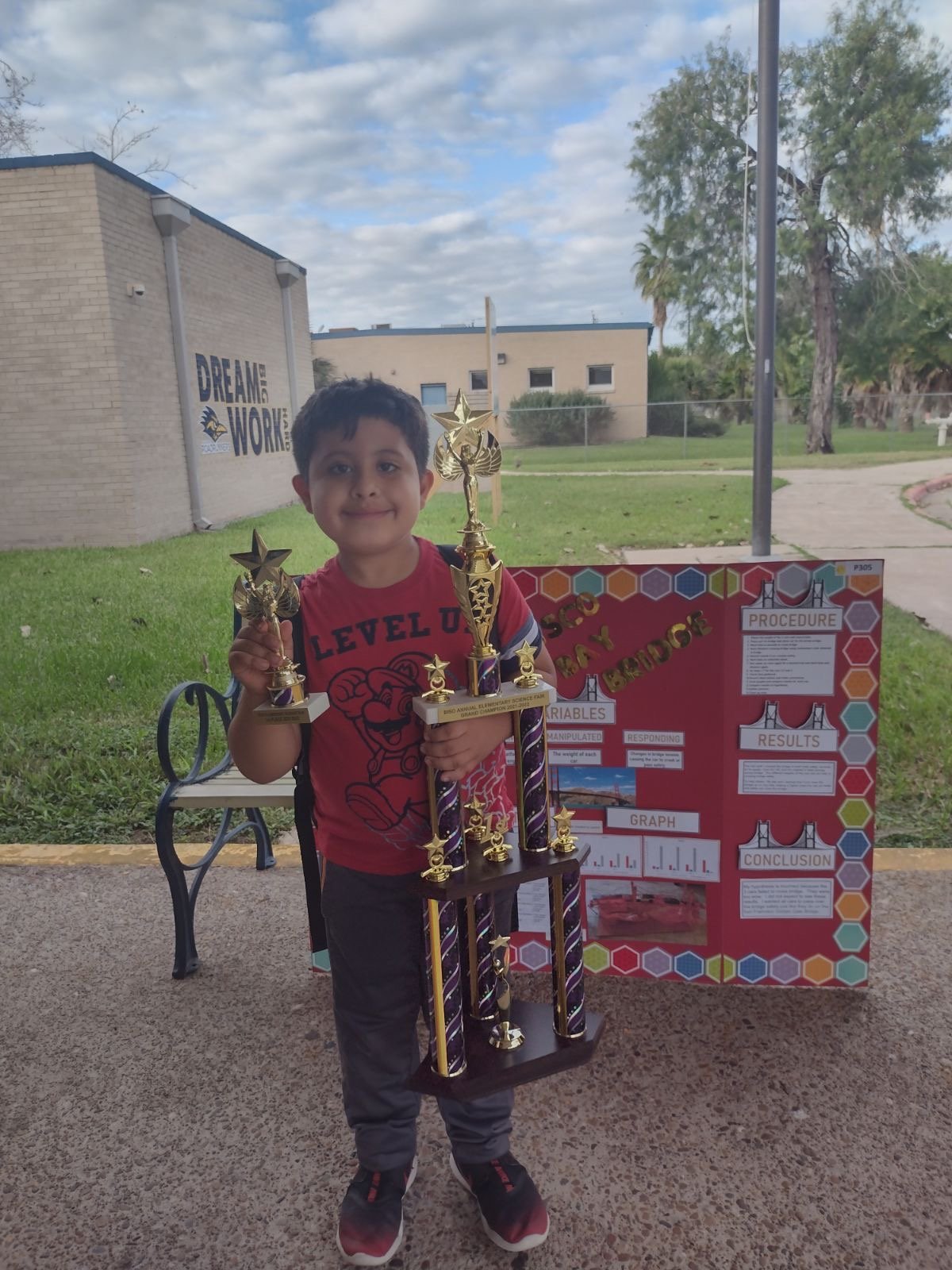 Timothy Murray shows off his trophy from the annual Brownsville ISD Elementary Science Fair in November 2022.