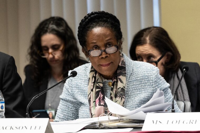 Sheila Jackson Lee, a Black woman, sits in a committee chair in front of a microphone in her position as a member of the U.S. Congress. She's currently one of two mayoral candidates in Houston's run-off election.
