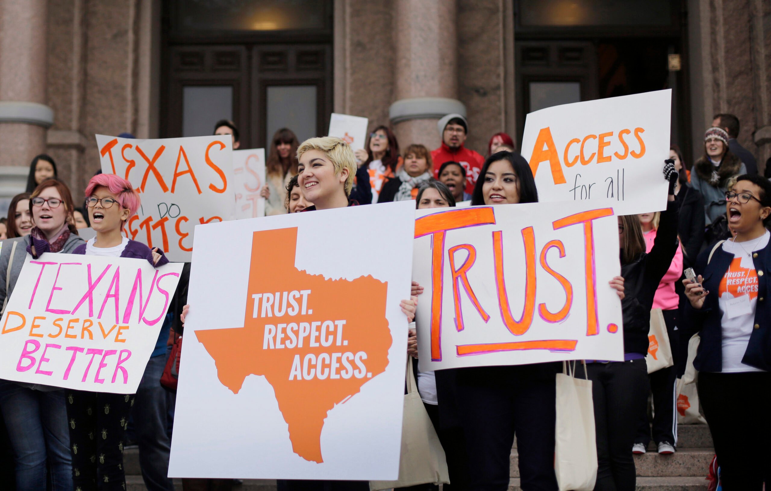 College students and abortion rights activists hold signs during a rally on the steps of the Texas Capitol in February 2015.