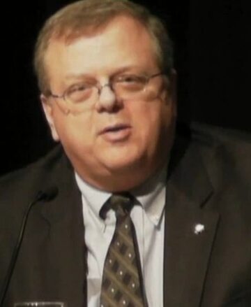 Paul Bettencourt, a white man in a suit with a argyle patterned tie.