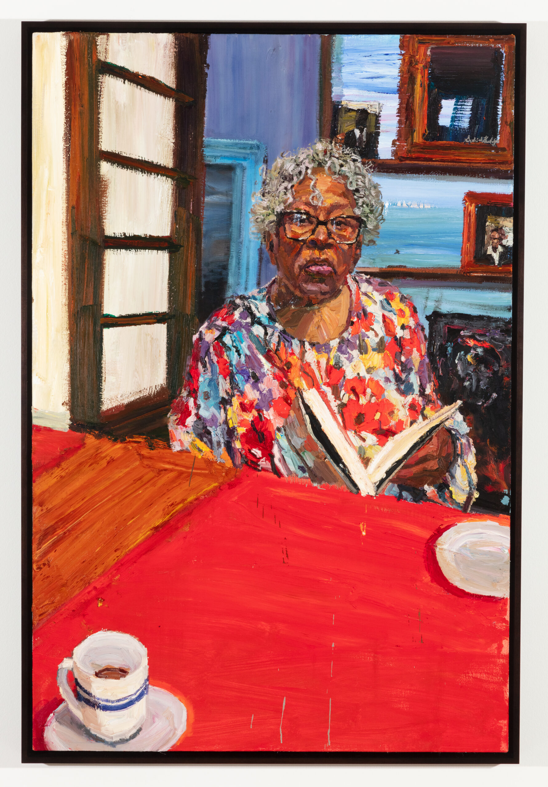 An oil-painting of a seated elderly Black woman, reading a book at a red table while wearing a floral dress and glasses.